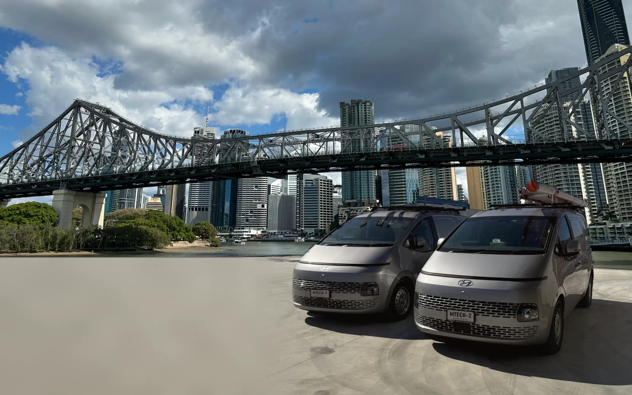 M-Tech Electrical vans with the Story Bridge and Brisbane city behind